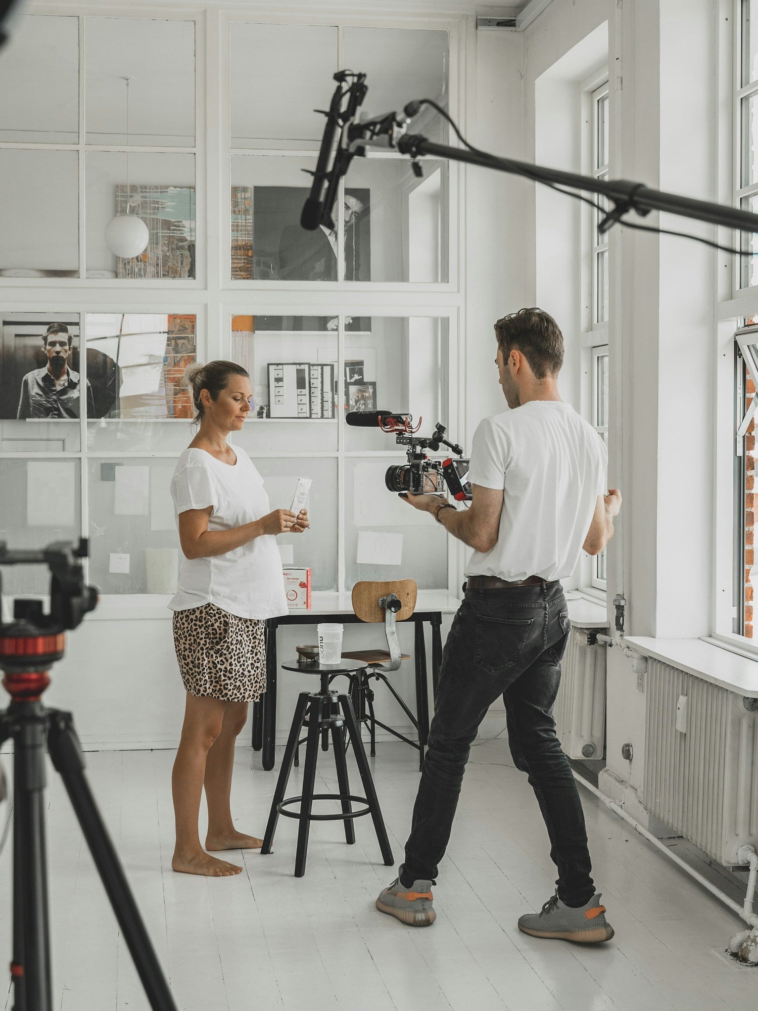 Man photographing a woman in a photo studio